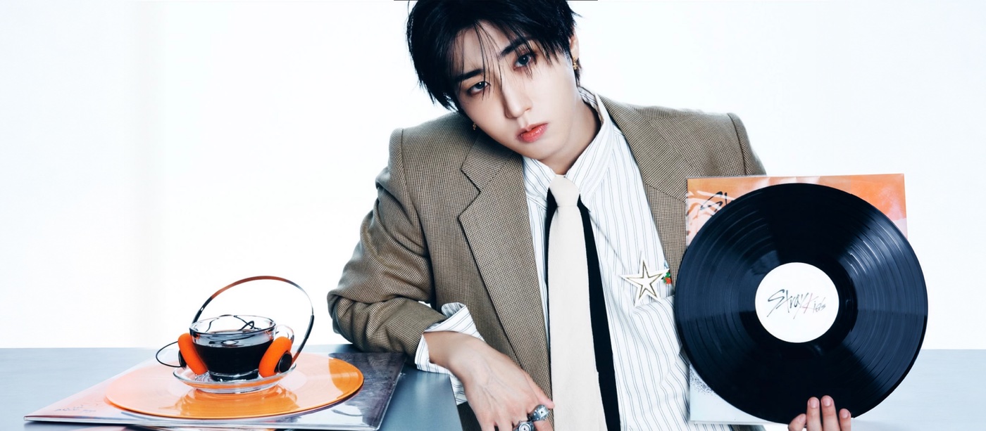 Han Back to Life cover portrait with a vinyl record, striped shirt and orange headphones