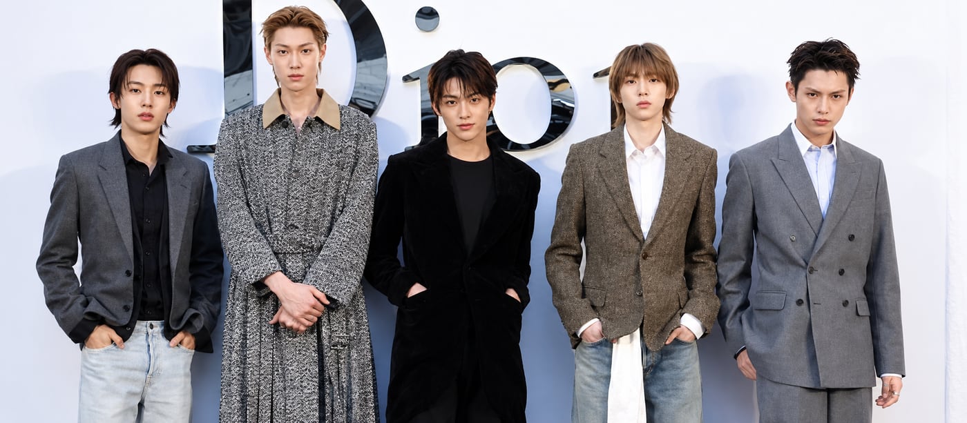 CORTIS members in tailored suits and coats at a Dior photocall.