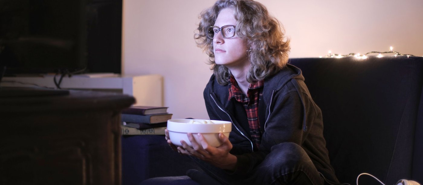 Viewer with a bowl of popcorn watching TV at home at night, for the new K-dramas of November 2026